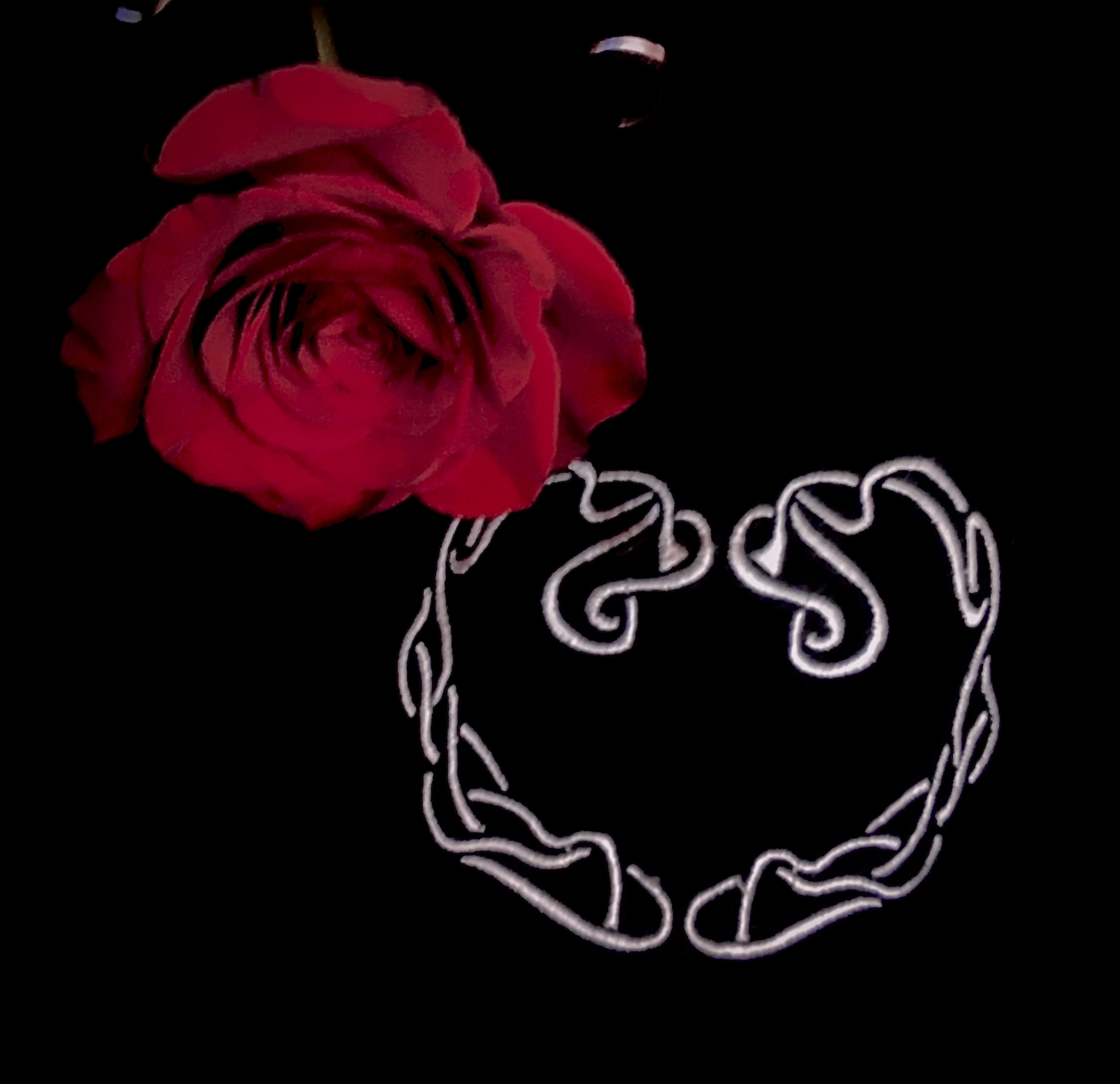 Flower on heart sweater — the Heart mark rendered as a silver chain beside a red rose, 2025